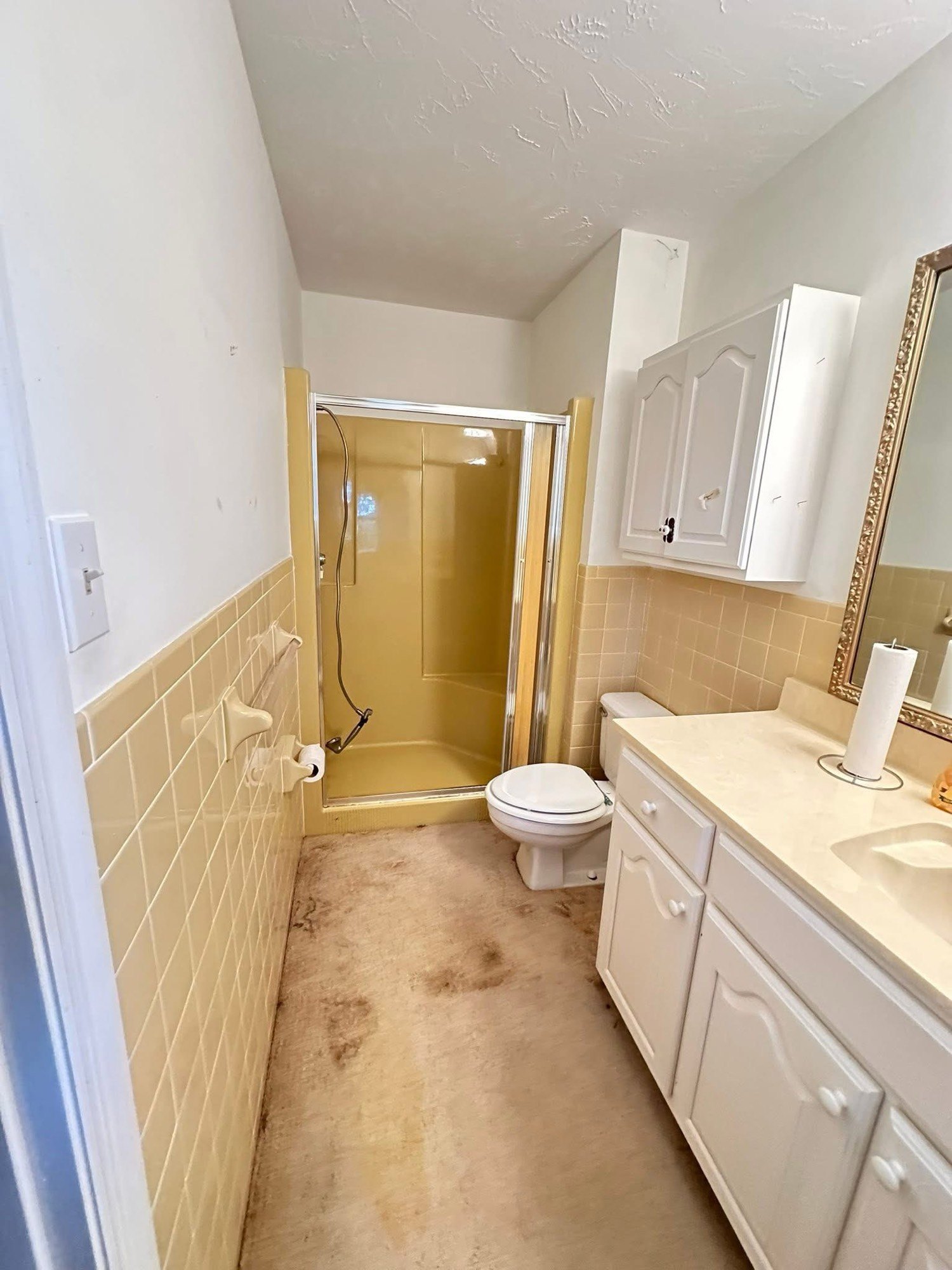 Bathroom before remodel with yellow tile