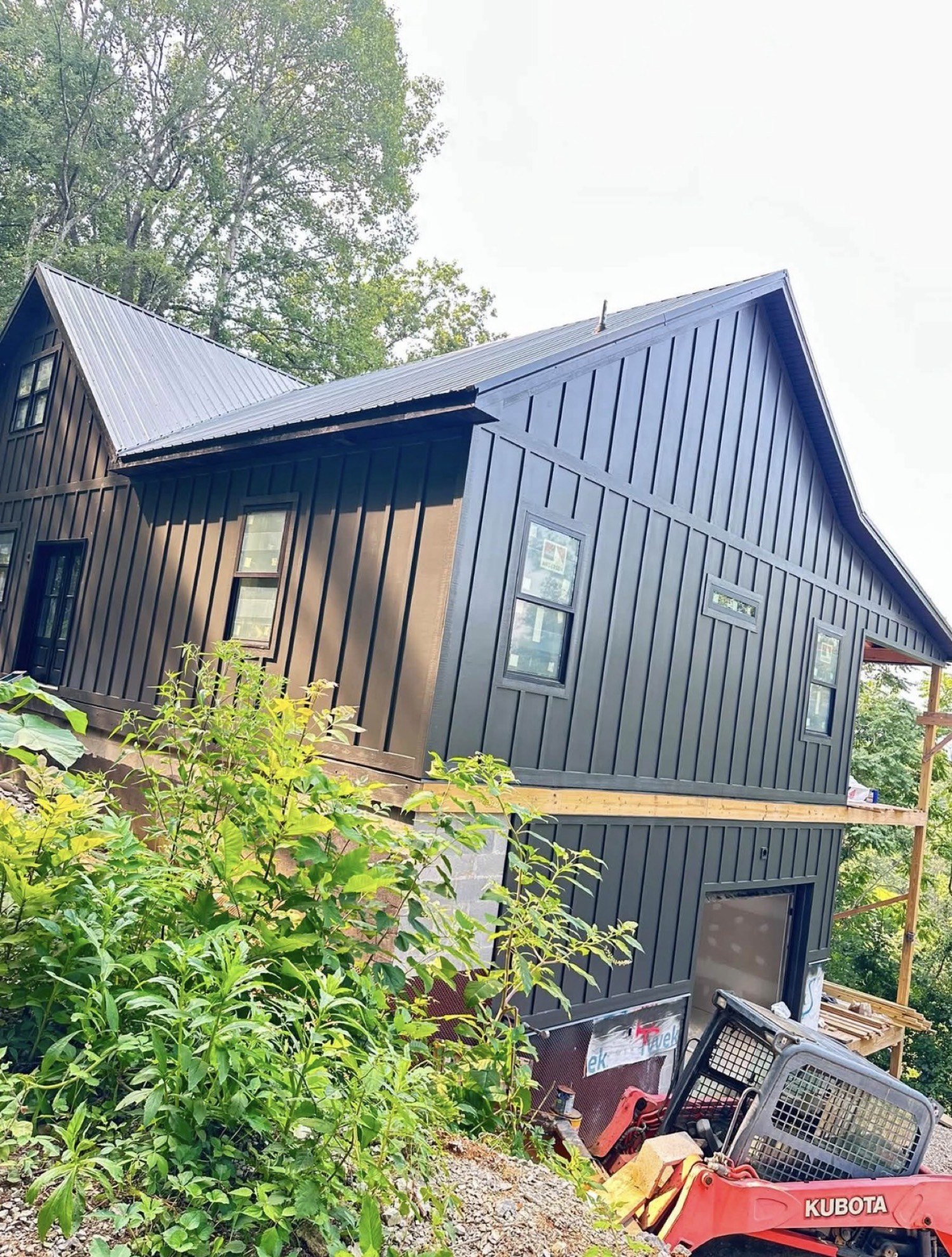 Same house after dark board-and-batten paint