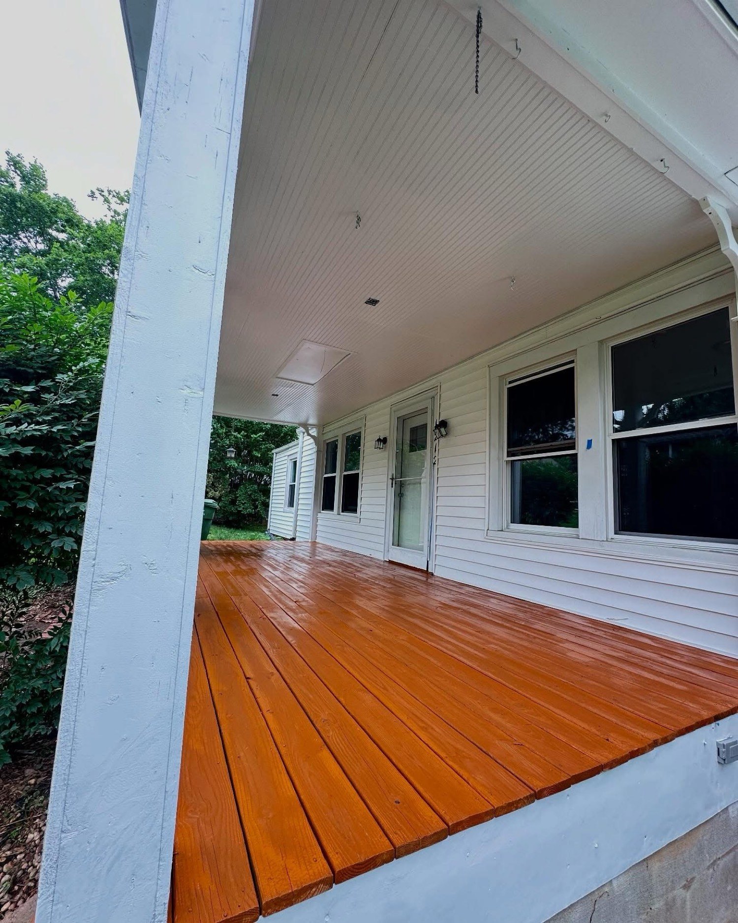 Front porch after stained deck and white paint