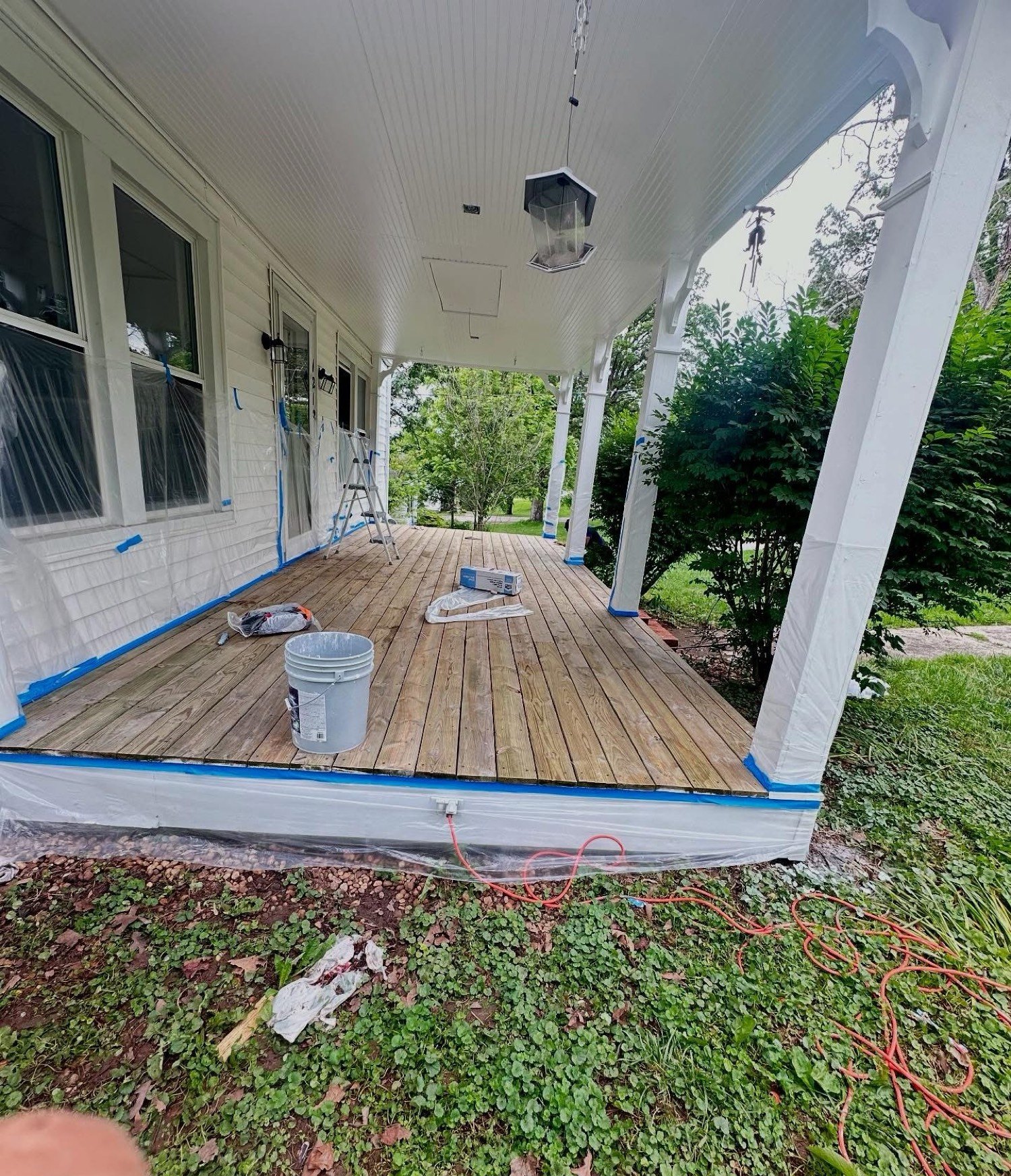 Front porch with raw deck boards during prep