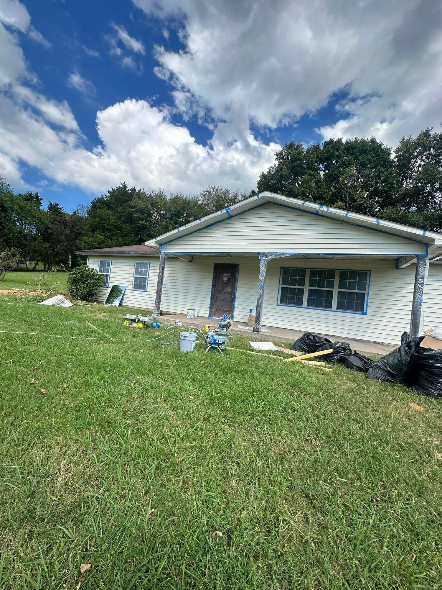 Ranch house taped and primed for exterior paint